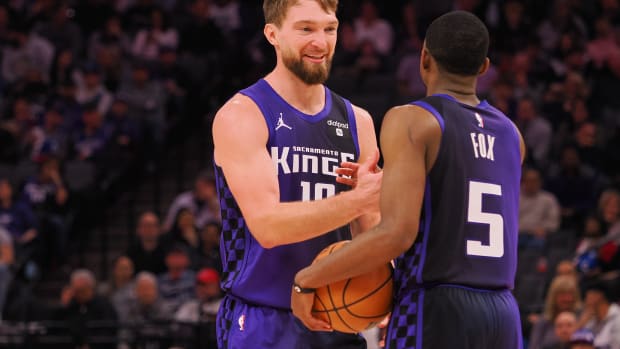 Feb 9, 2024; Sacramento, California, USA; Sacramento Kings center Domantas Sabonis (10) smiles with guard De'Aaron Fox (5) after a play against the Denver Nuggets during the second quarter at Golden 1 Center. Mandatory Credit: Kelley L Cox-USA TODAY Sports